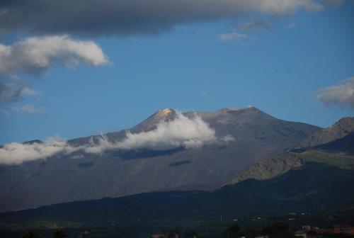 a view of a mountain with clouds in the sky at B&B Villa Maria in Giarre
