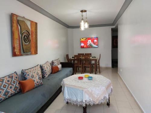 a living room with a couch and a table at apartment in centre ville in Rabat