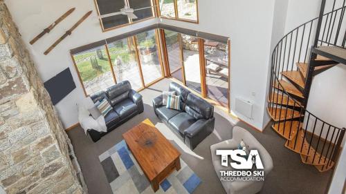 an overhead view of a living room with two couches and a table at Ski Fall at Lake Crackenback in Crackenback