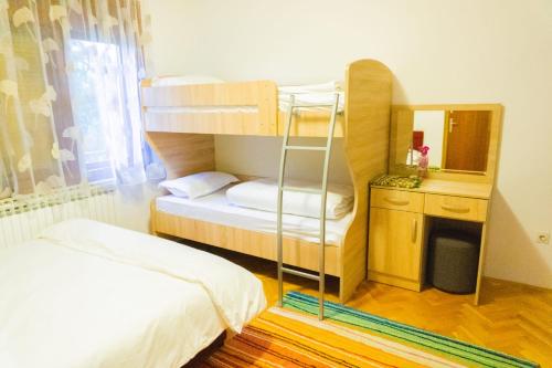 a room with two bunk beds and a mirror at Dhabi Sweet Home in Doglodi