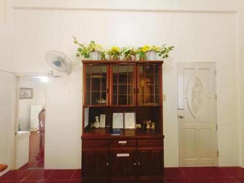 a wooden cabinet with flowers on top of it at The Beach Villa by M in Manguisoc