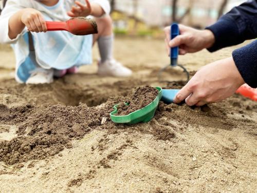 a child playing in the dirt with a shovel at Matsue Forest Park in Matsue