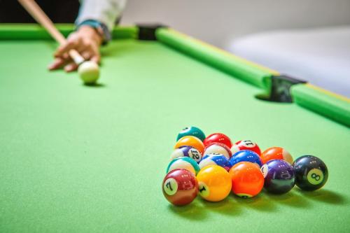 a man playing a game of pool on a pool table at Hotel POCO Seongsu in Seoul