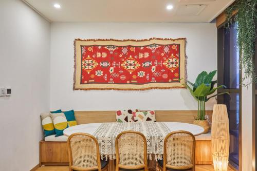 a dining room with a table and chairs and a red rug at Hotel POCO Seongsu in Seoul