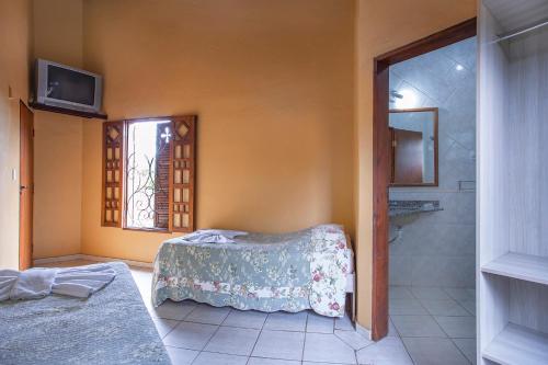 Ένα ή περισσότερα κρεβάτια σε δωμάτιο στο Hotel Alemão Beach de Ilhabela
