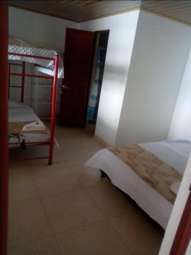 a bedroom with two bunk beds and a door to a room at Finca villa sofia in Albán