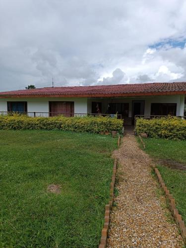 a house with a grass yard in front of it at Finca villa sofia in Albán