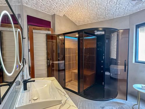a bathroom with a shower and a sink at Rancho Bernardo Luxury Villas and Resort in Bagac