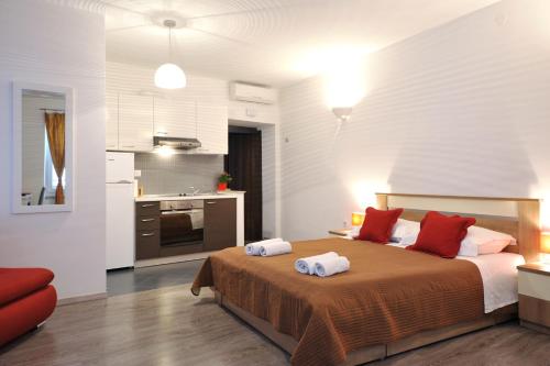 a bedroom with a bed with two towels on it at Rooms & Apartments 72 in Zadar