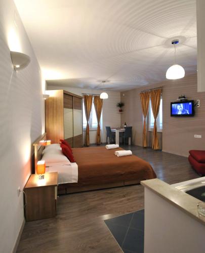 a hotel room with a large bed and a sink at Rooms & Apartments 72 in Zadar