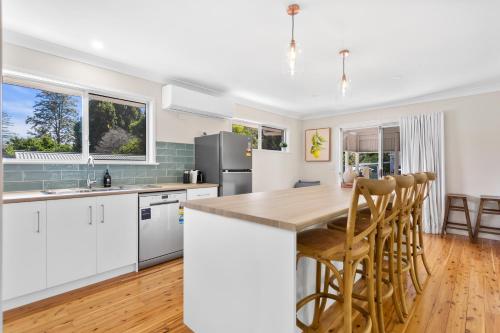a kitchen with white cabinets and a counter top at Maple Cottage - Perfect Eastside Location in Toowoomba