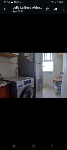 a kitchen with a refrigerator and a washing machine at Departamento en la Boca piso 11 vista panoramica in Buenos Aires