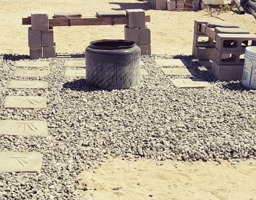 a park bench and a trash can in the sand at Baja's Rest Stop in San Felipe