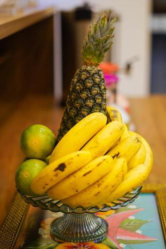 a bowl of fruit with bananas and pears on a table at Verdant hotel in Bonito