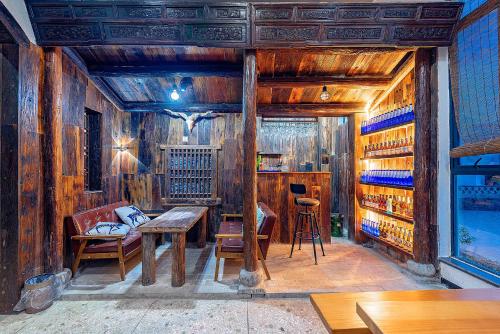 a room with wooden walls and a table and chairs at Tea Rhythm House Yangshuo in Yangshuo