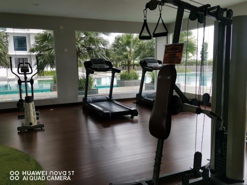 a gym with treadmills and ellipticals in a building at Platino Aparment @ Paradigm Mall in Johor Bahru