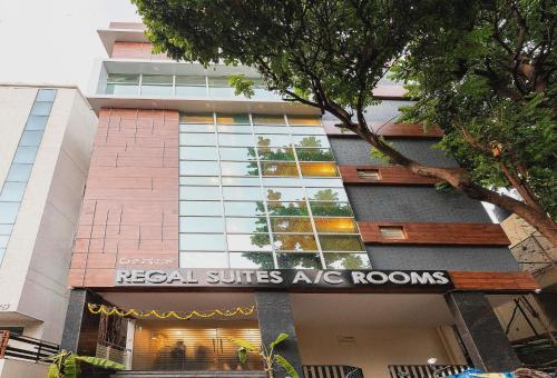 a building with a sign that reads real suites ac rooms at Capital O Regal suites in Bengaluru