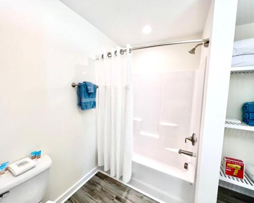 a bathroom with a shower and a toilet at Saltwater 106 1st Floor Low Tide in Surf City