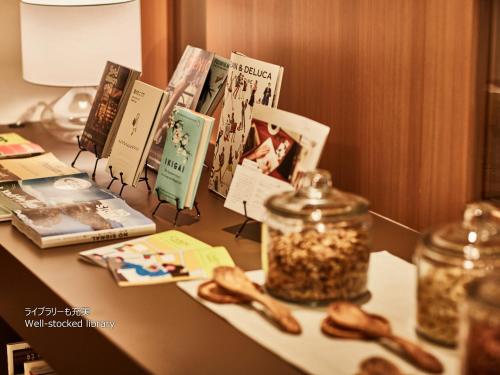 a table with books and a jar of seeds on it at First Cabin Nishi Umeda in Osaka