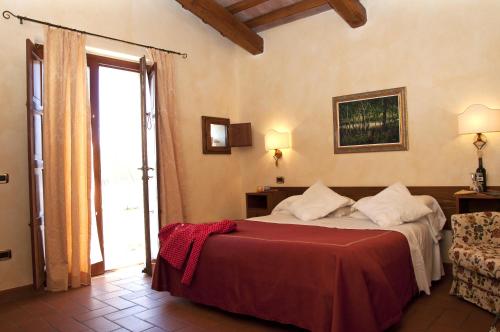Postel nebo postele na pokoji v ubytování Agriturismo Lupo Cerrino