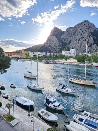 a group of boats are docked in a river at Apartman River Breeze in Omiš
