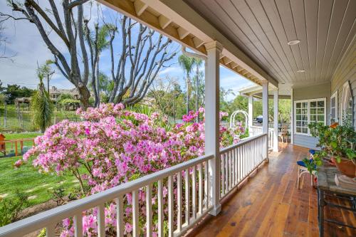 a porch of a home with pink flowers at Stunning Home in Orange County with Stables! in Orange