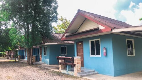 een blauw huis met een bankje ervoor bij Ban Rai Plai Na บ้านไร่ปลายนารีสอร์ท 