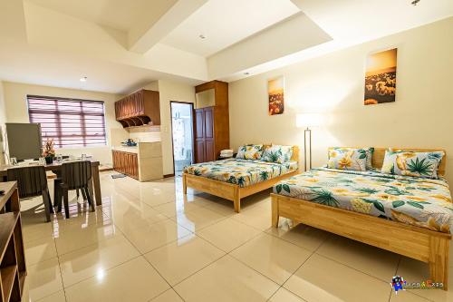 a living room with two beds and a kitchen at Verjandel Residences in Manila