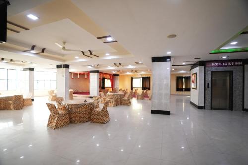 a lobby with chairs and tables in a building at Hotel Lotus Inn near Udaipur City Railway Station in Udaipur