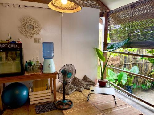 a living room with a fan and a window at Casita Francisco Siargao in General Luna