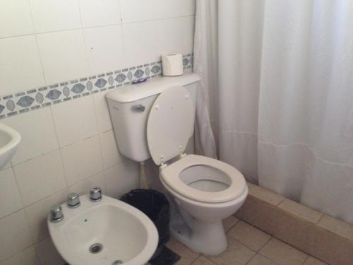 a bathroom with a toilet and a sink at La Posada del Parque con baño privado in Salta