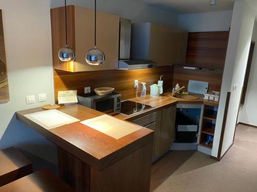 a kitchen with a wooden counter top and a sink at Glass House Kosice in Košice