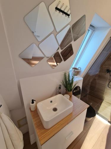 a bathroom with a white sink and a mirror at Cabanele A Frame, Salciua Noua in Sălciua Nouă