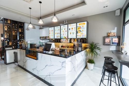 フーコックにあるLeeVi Homestay - Coffee - Milkteaのカウンターとスツール付きのレストランのバー
