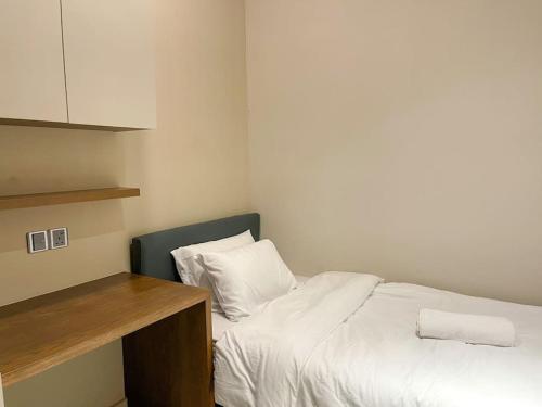 a small bedroom with a white bed and a counter at Cosy Ins Genting view 2 Bedrooms Home at Geo38 Premier Suites with 100mpbs WiFi available in Genting Highlands