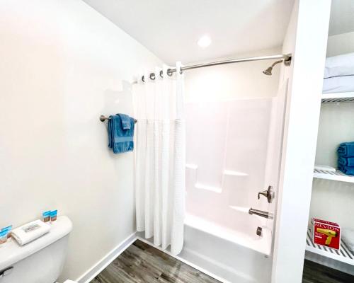 a bathroom with a shower and a toilet at Saltwater 202 2nd Floor Low Tide in Surf City