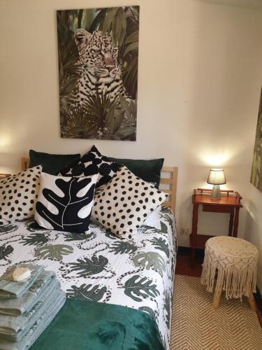 a bedroom with a bed with black and white pillows at Sondela Self Catering in São Martinho do Porto