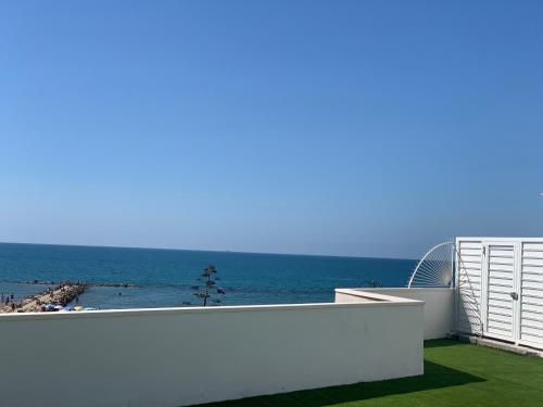 a view of the ocean from the balcony of a house at I Bordin Home in Nettuno
