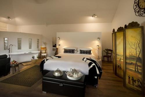 a bedroom with a large bed and a bath room at The Villa in Morpeth