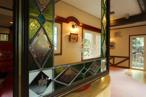 a room with stained glass windows on the wall at Landhaus Dancru Netz in Hakuba