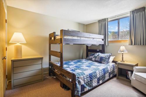 a small bedroom with a bunk bed and a bed at Pinnacle A23 in Killington