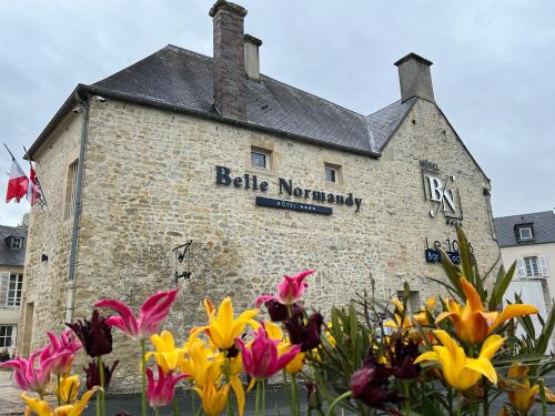a brick building with a sign on the side of it at Belle Normandy in Bayeux
