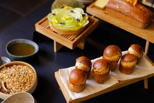 a table topped with bread and buns and other foods at Via Roma 33 Tuscany Boutique Hotel & Spa - Adults Only in Stia