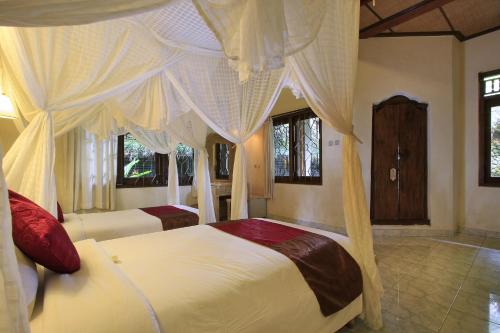 Un ou plusieurs lits dans un hébergement de l'établissement Nick's Hidden Cottages by Mahaputra-CHSE Certified