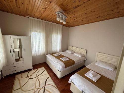 a bedroom with two beds and a window at Sea & Nature Villa Hisar in Trabzon
