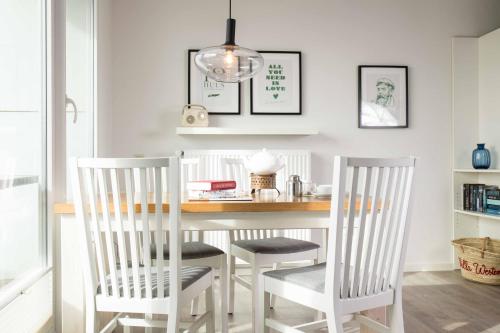 a dining room with a table and two chairs at Villa Westend in Norderney