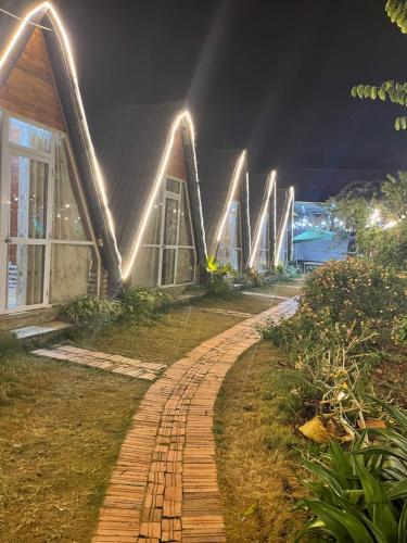 a brick path in front of a building at night at Homestay Bình Huy in Mộc Châu