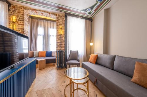 a living room with a couch and a tv at Hotel Balo in Istanbul
