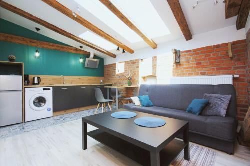 a living room with a couch and a table at Apartamenty na Starym Mieście in Gliwice