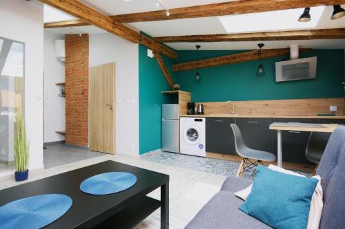 a living room with a couch and a table at Apartamenty na Starym Mieście in Gliwice